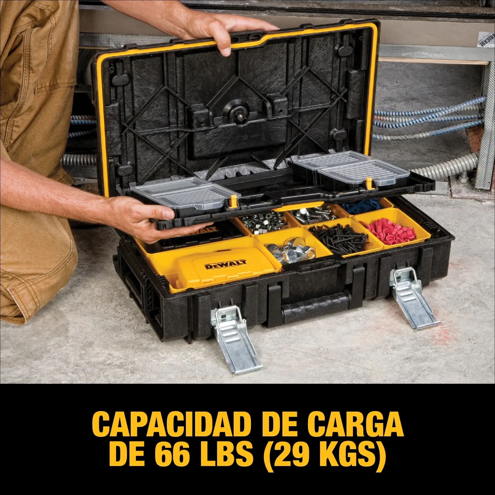 A person opens a DEWALT tool box with various compartments containing hardware and accessories, showing a load capacity of 66 lbs (29 kgs).