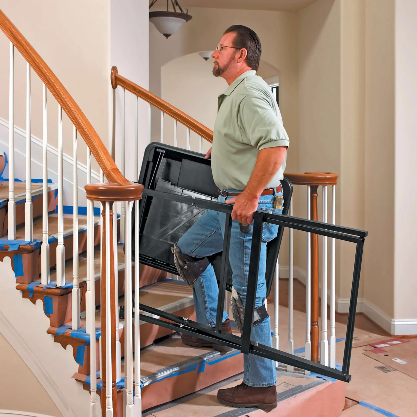 wet tile saw base being carried by person on stairs