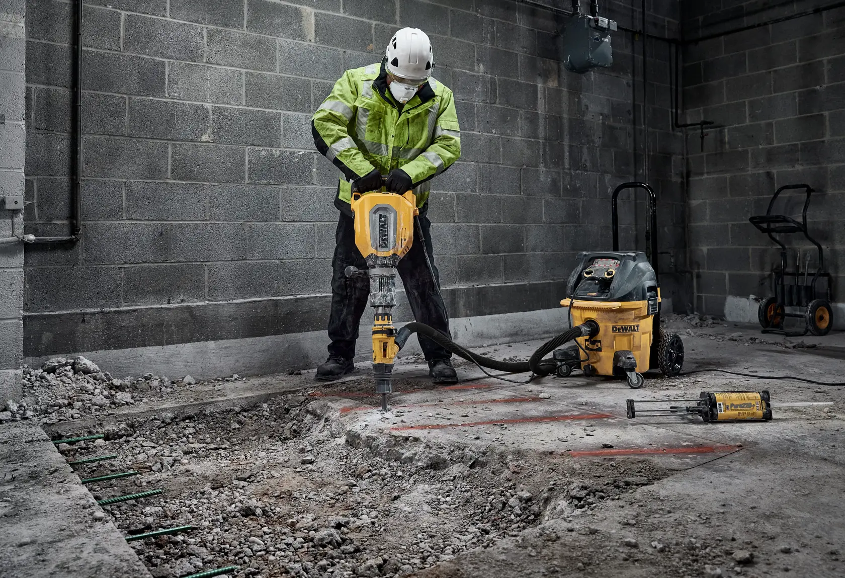 Worker using a chipping hammer D25911K to break up concrete