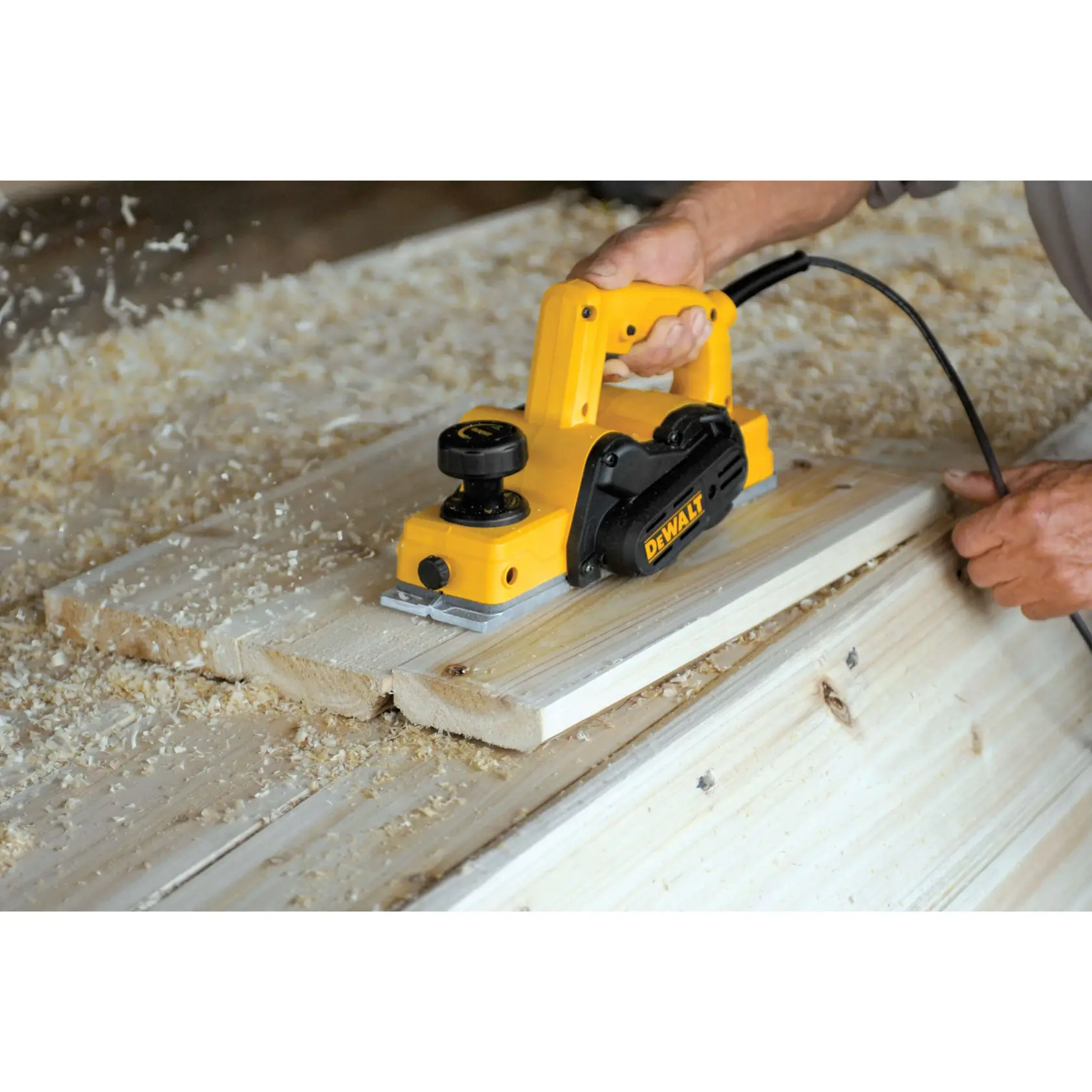 DEWALT Person using Portable Hand Planer to cut wood