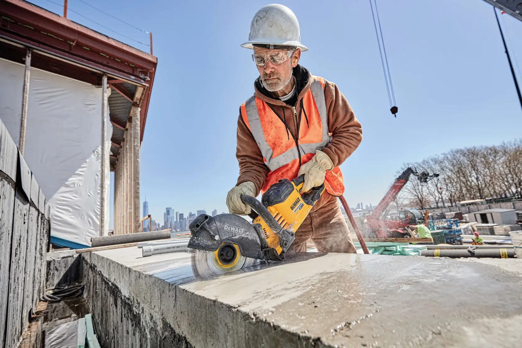 20 Volt to 60 Volt 12 AMP hours Lithium Ion Battery powered Circular Saw being used by a construction worker to cut concrete at a construction site
