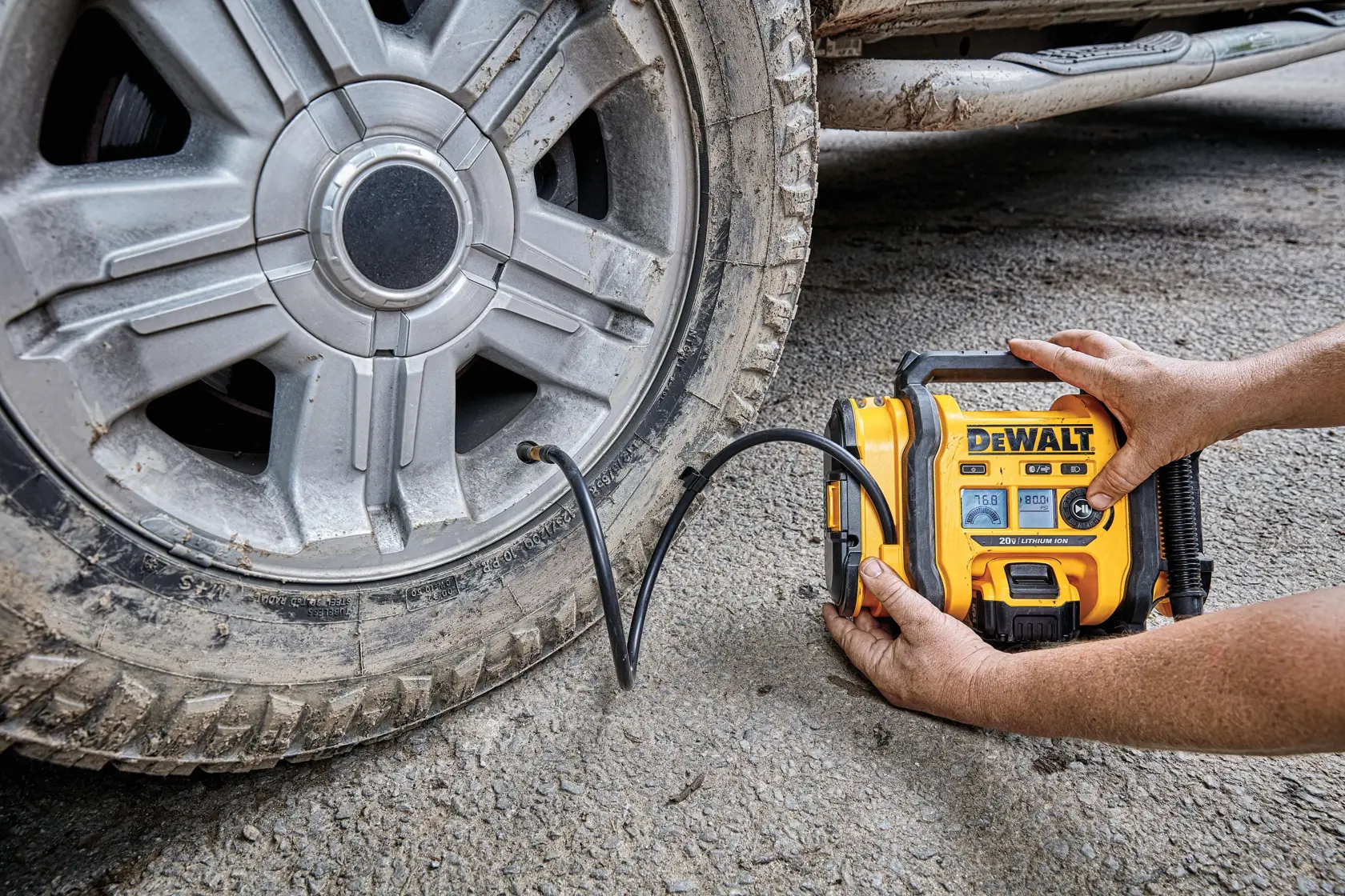 Corded/Cordless Air Inflator being used by a person to inflate a tire