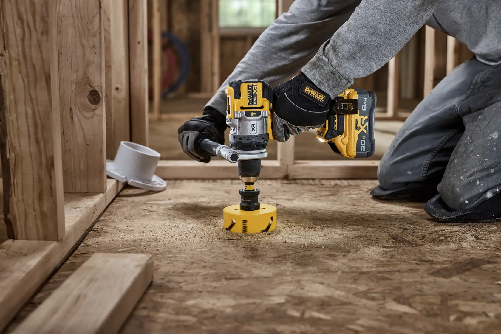 20V MAX* XR® Brushless Cordless 1/2 in. Hammer Drill drilling 4" hole for plumbing using a DEWALT hole saw