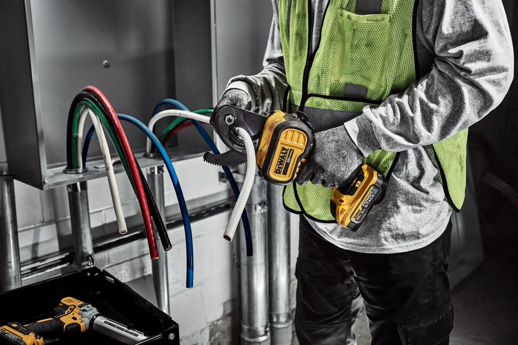 DEWALT Cable Cutter is used to cute cable to length by a tradesman in a electrical room.