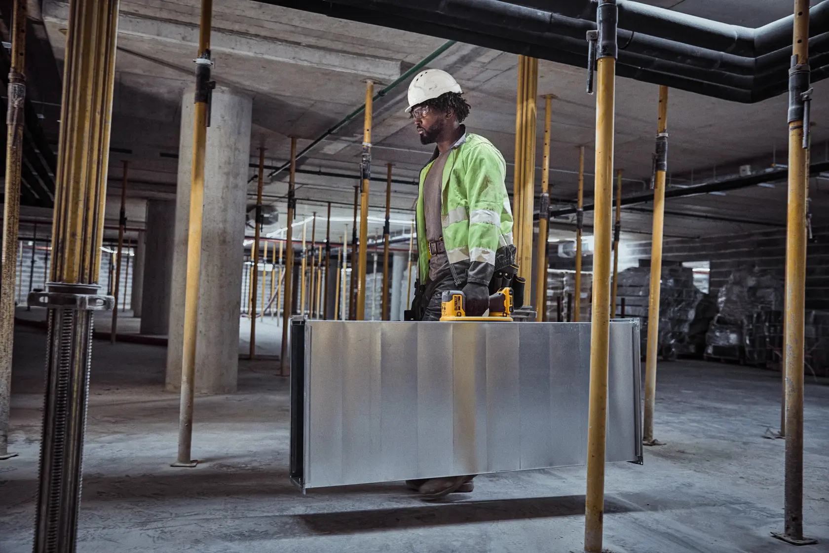 User lifting HVAC duck with DEWALT 20V MAX Grabo Lifter