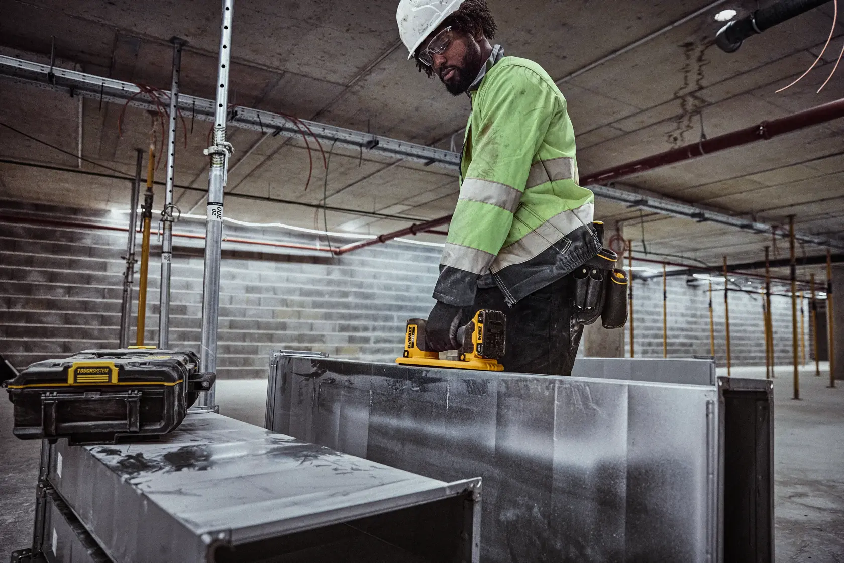 User lifting HVAC duck with DEWALT 20V MAX Grabo Lifter