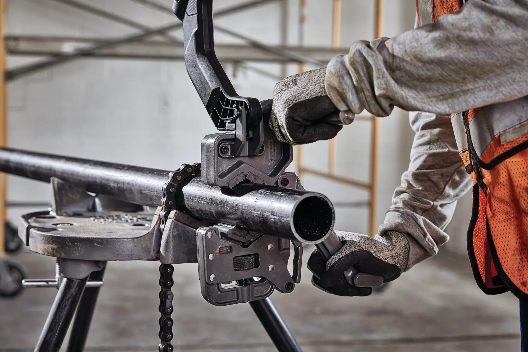 Pipe clamp holding black iron pipe.