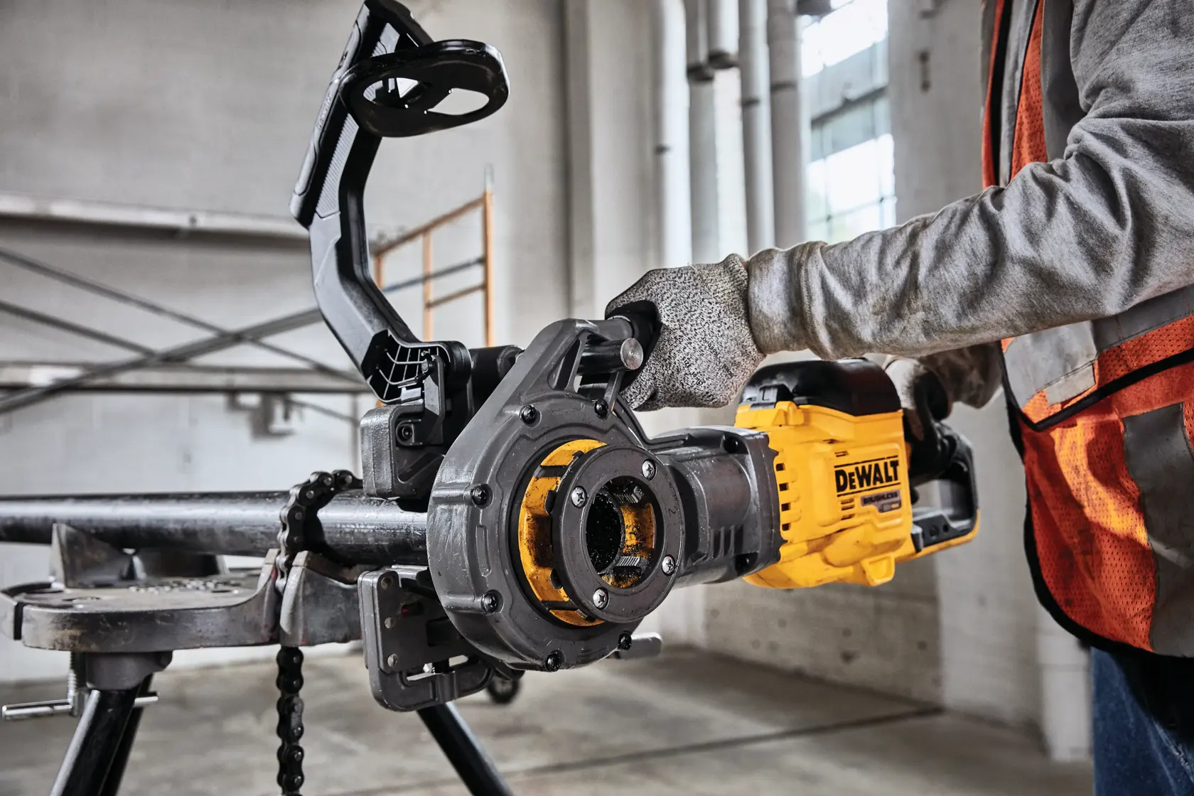 FLEXVOLT cordless pipe threader being set up on black iron pipe.