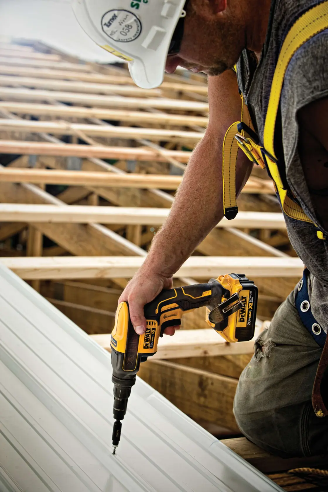 XR Versa-Clutch adjustable torque screw gun being used by person to fasten metallic roof panel.