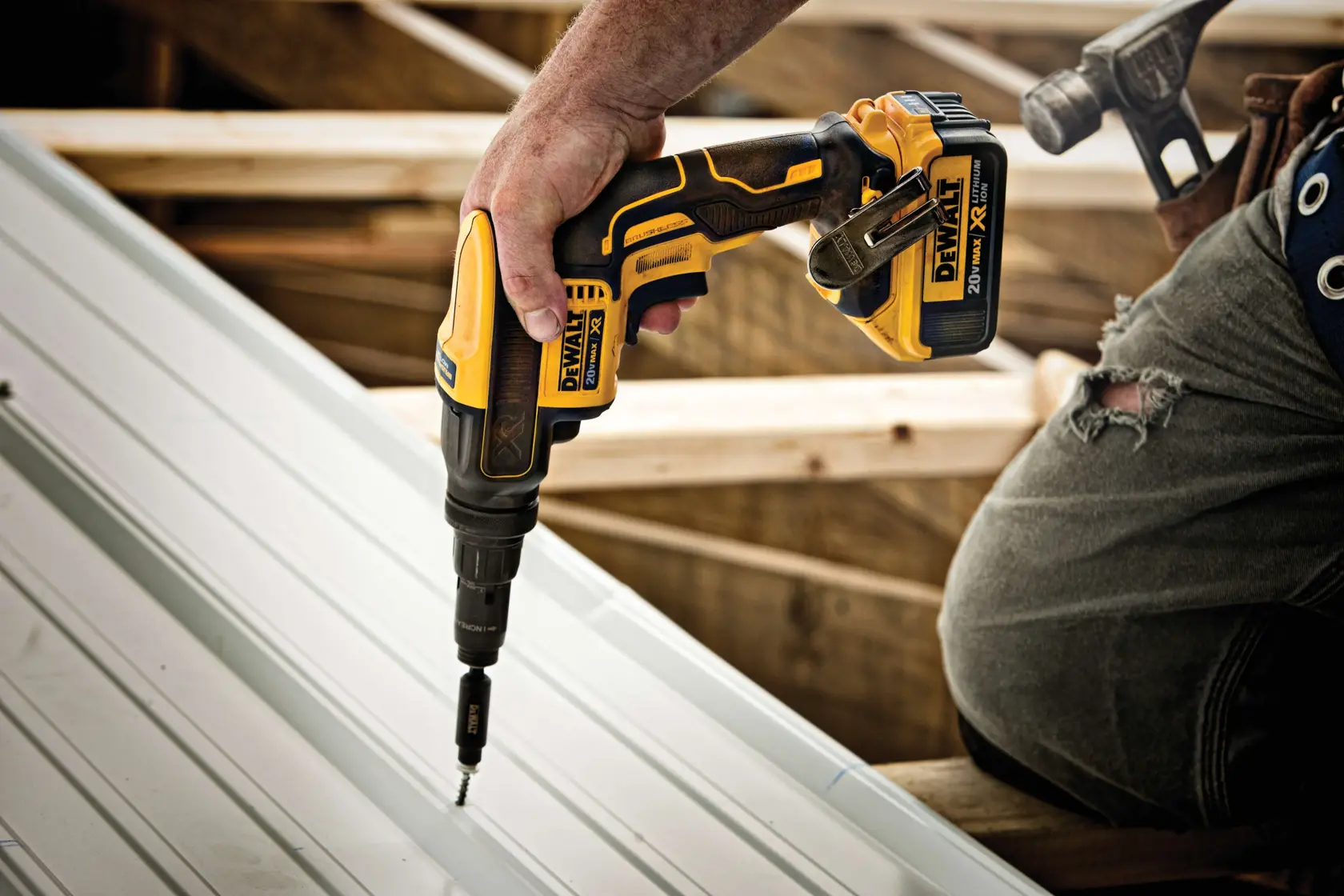 XR Versa-Clutch adjustable torque screw gun fastening screw through metal roof panel.