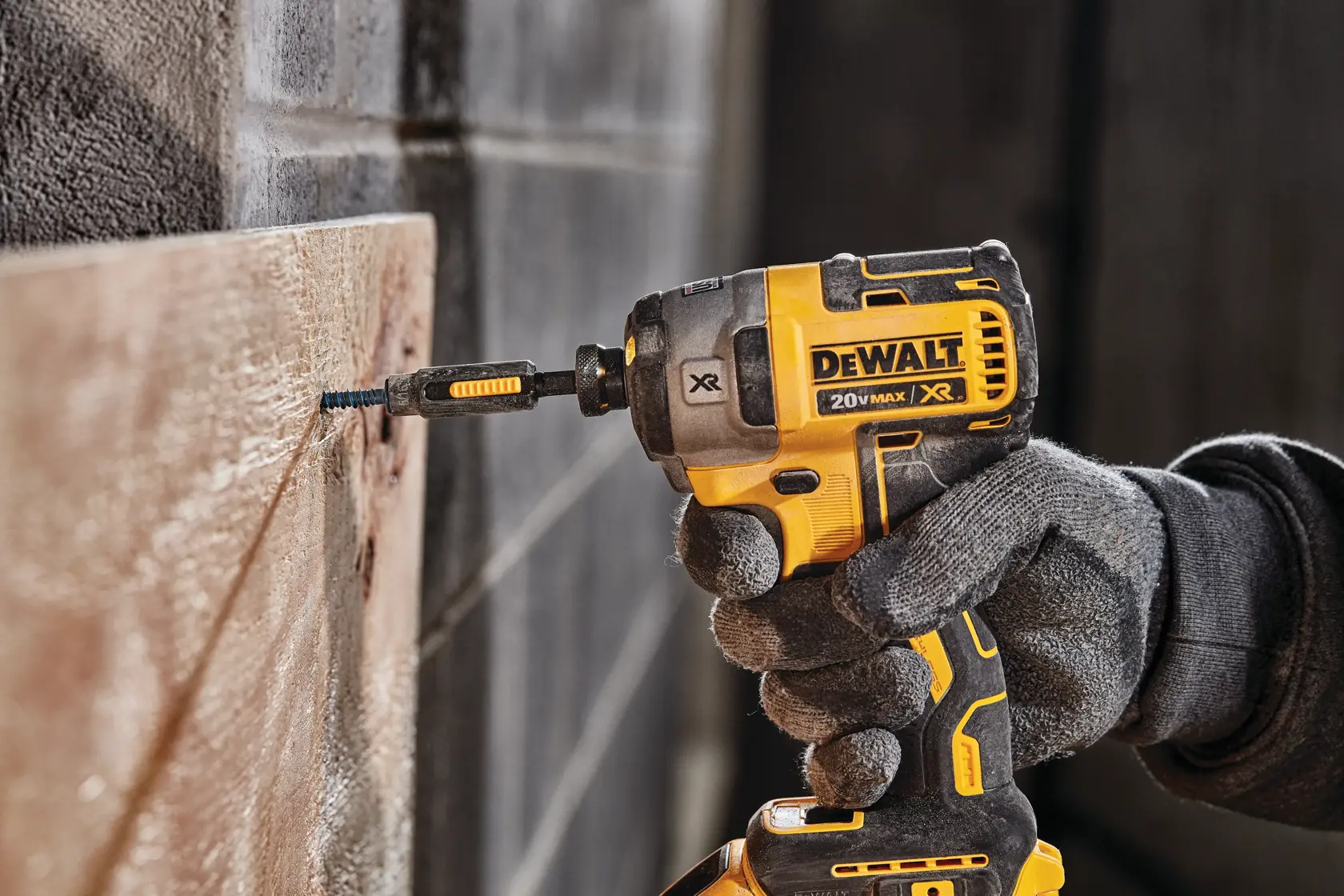 XR 3-speed impact driver fastening screw through wood on concrete.