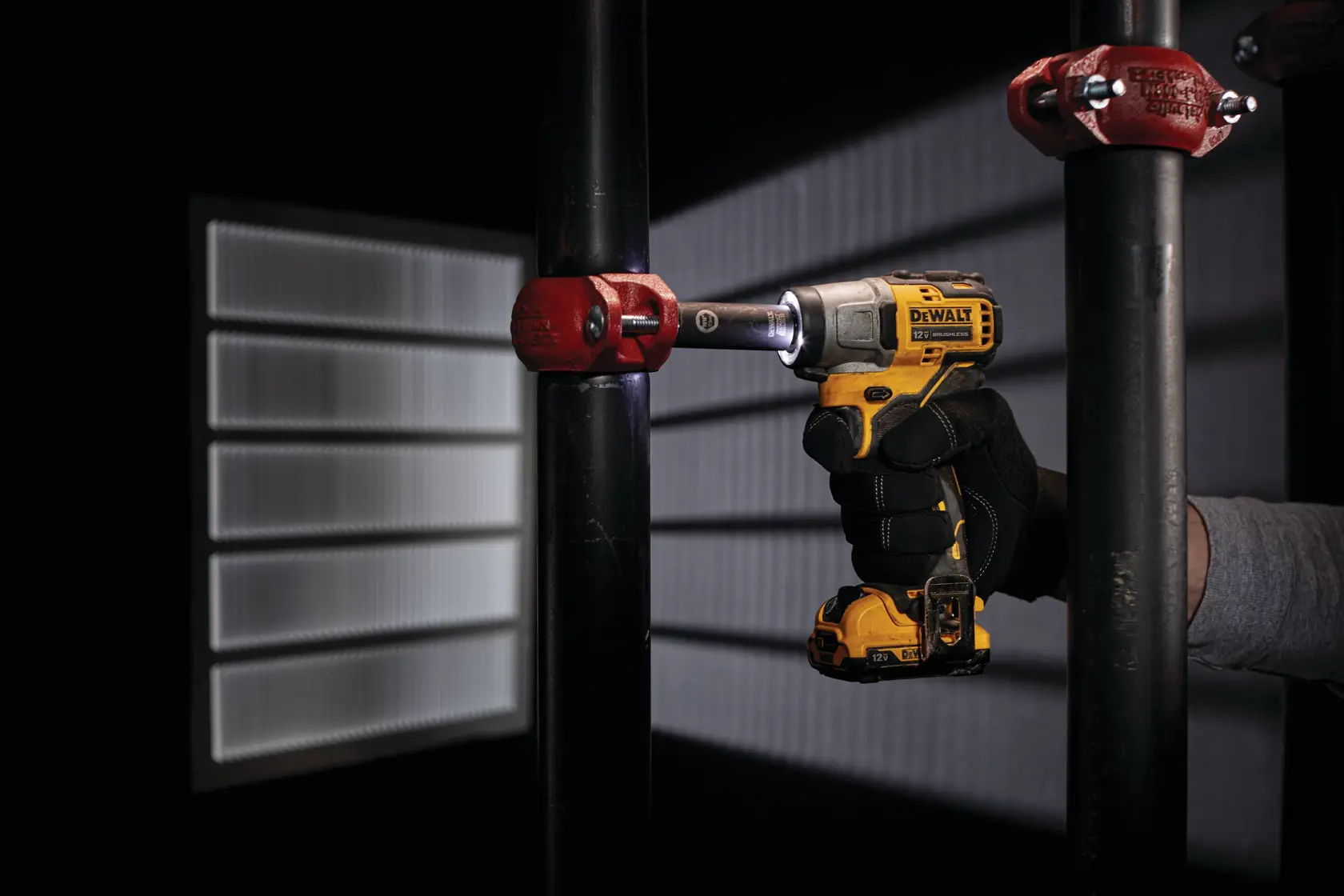 CORDLESS IMPACT WRENCH being used on a metal pipe