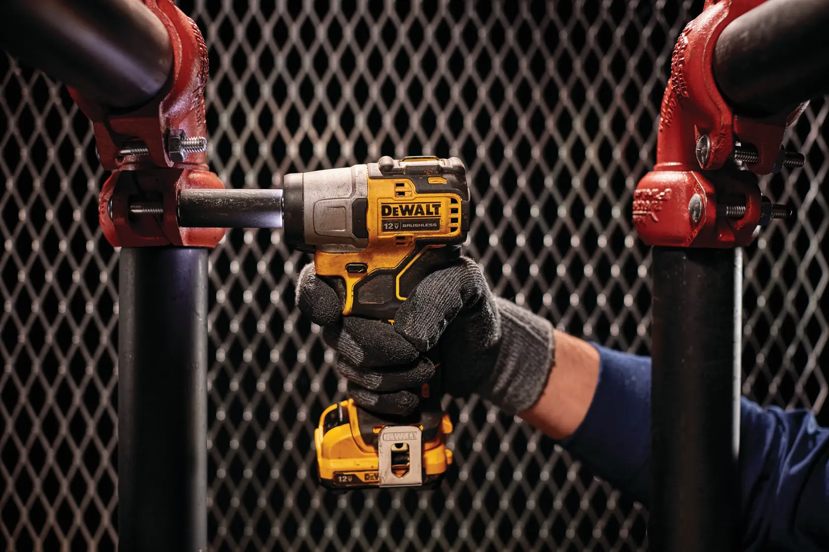 CORDLESS IMPACT WRENCH being used on a metal pipe