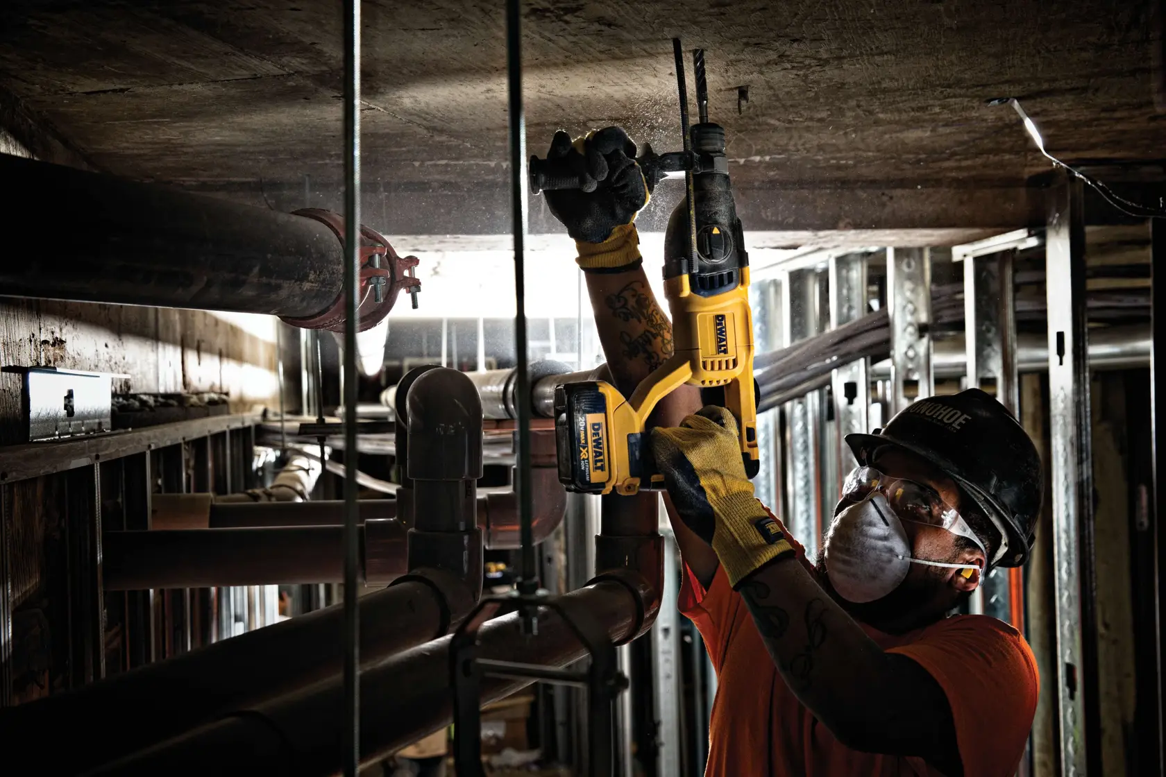 Brushless, cordless SDS PLUS D-Handle rotary hammer being used by a person