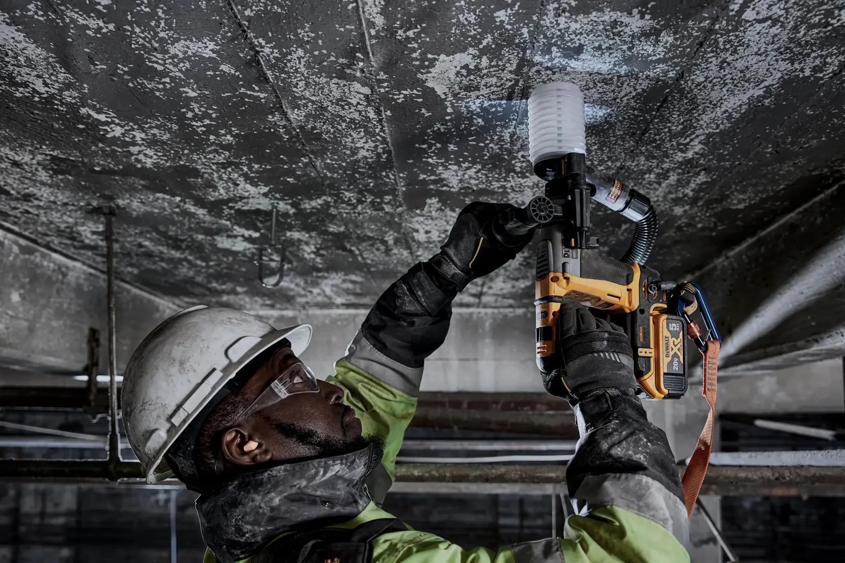 Atomic 20 volt five eighths inch brushless cordless S D S plus rotary hammer tool being used by a person.