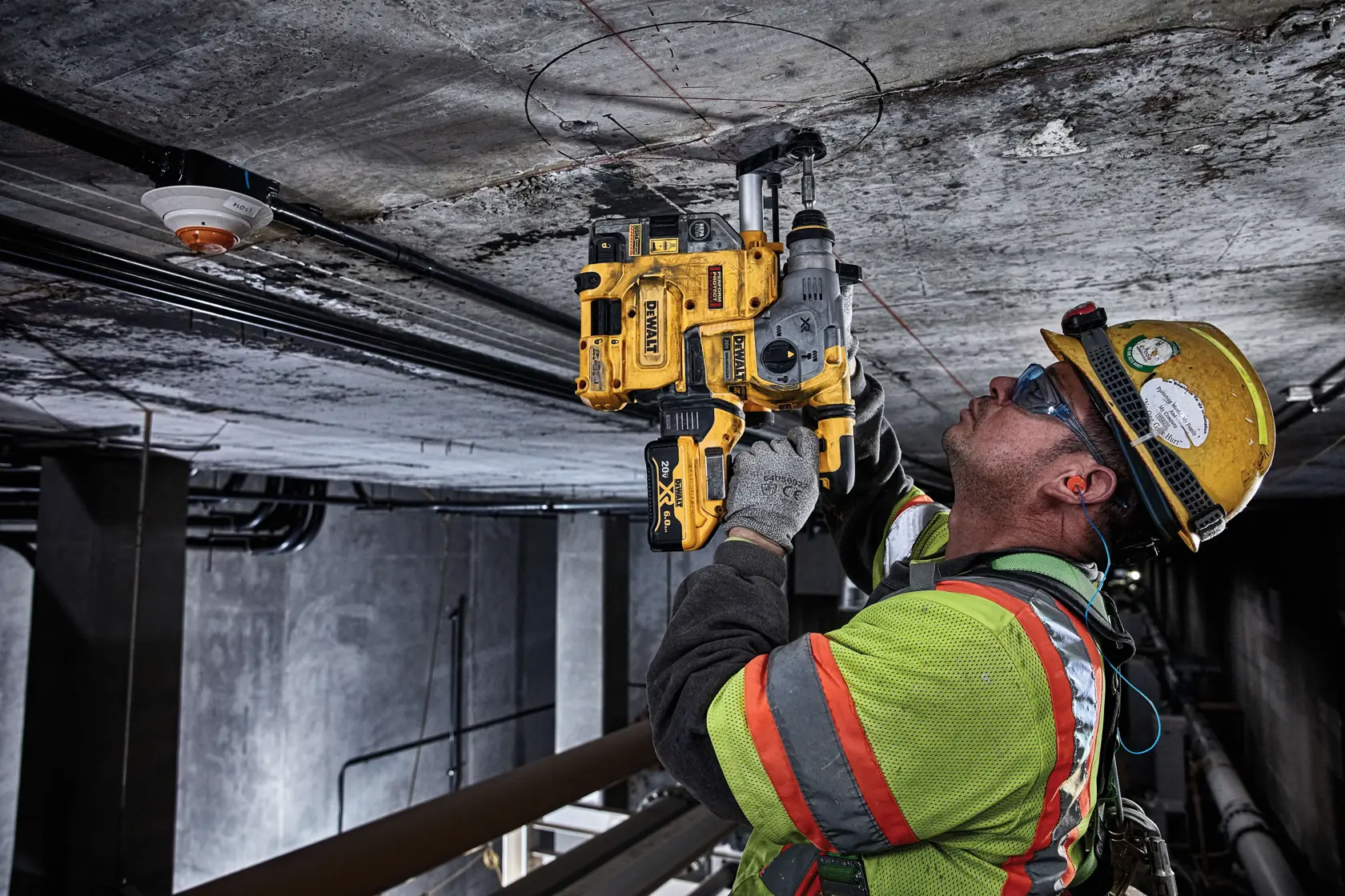 Brushless, cordless SDS PLUS L-shape rotary hammer being used by a person