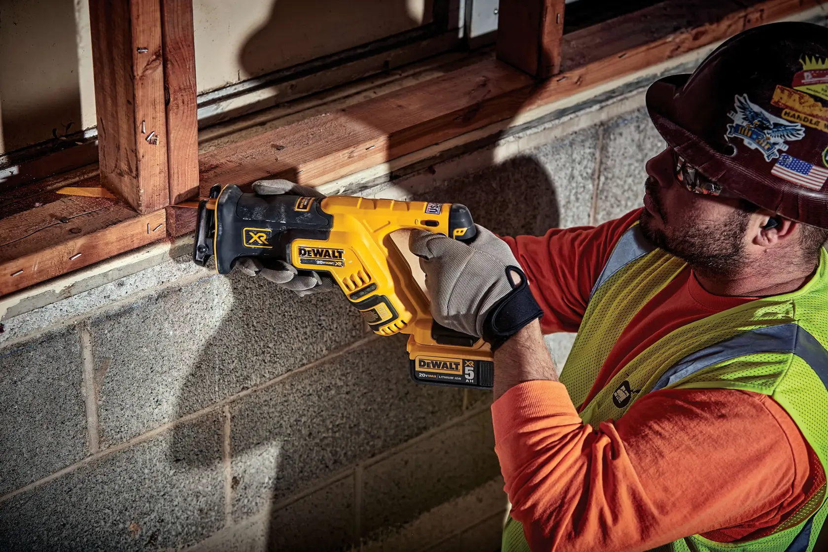 XR BRUSHLESS COMPACT RECIPROCATING SAW being used by worker on a wooden window sill plate