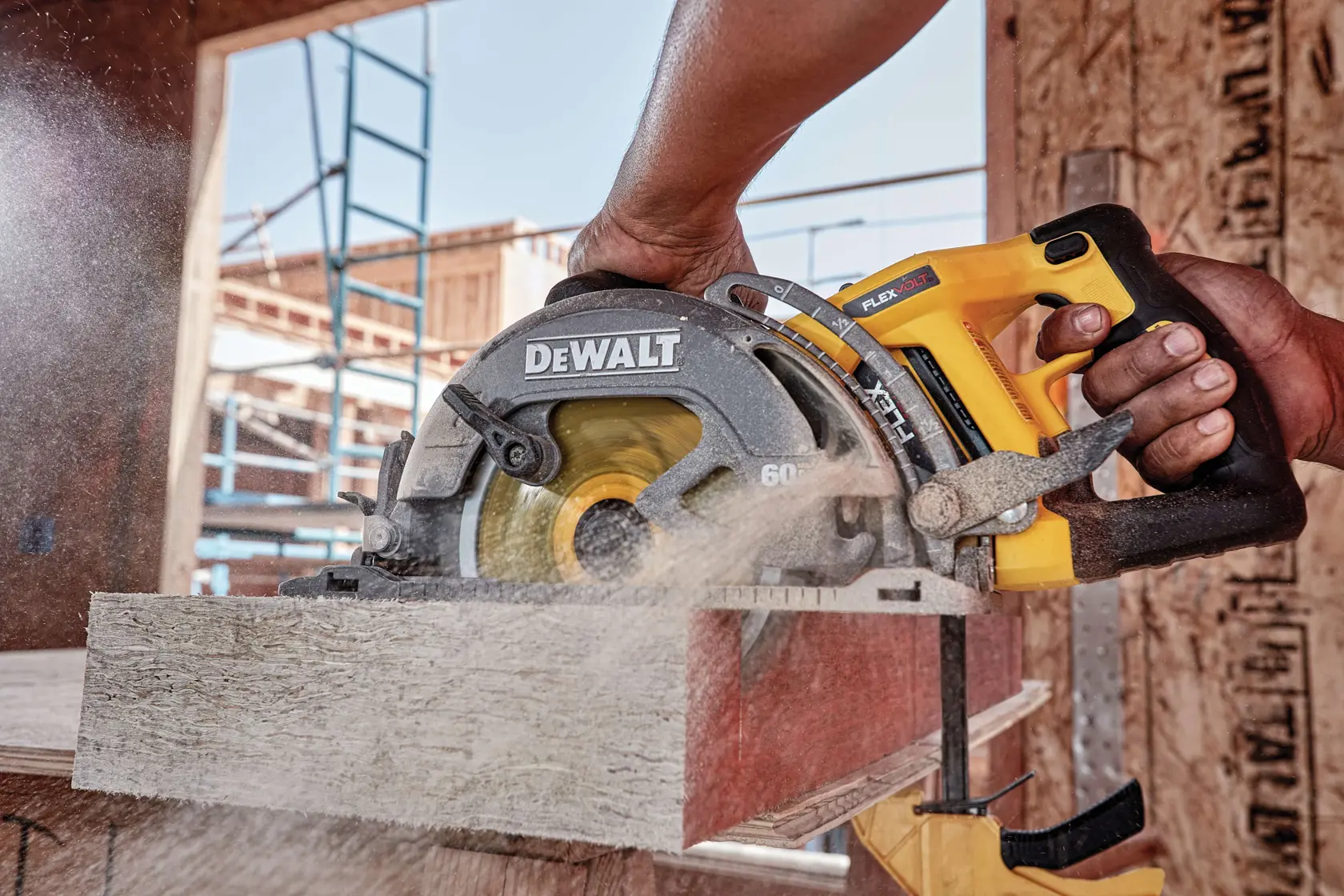 FLEXVOLT cordless worm drive style saw being used by person to cut wooden block.