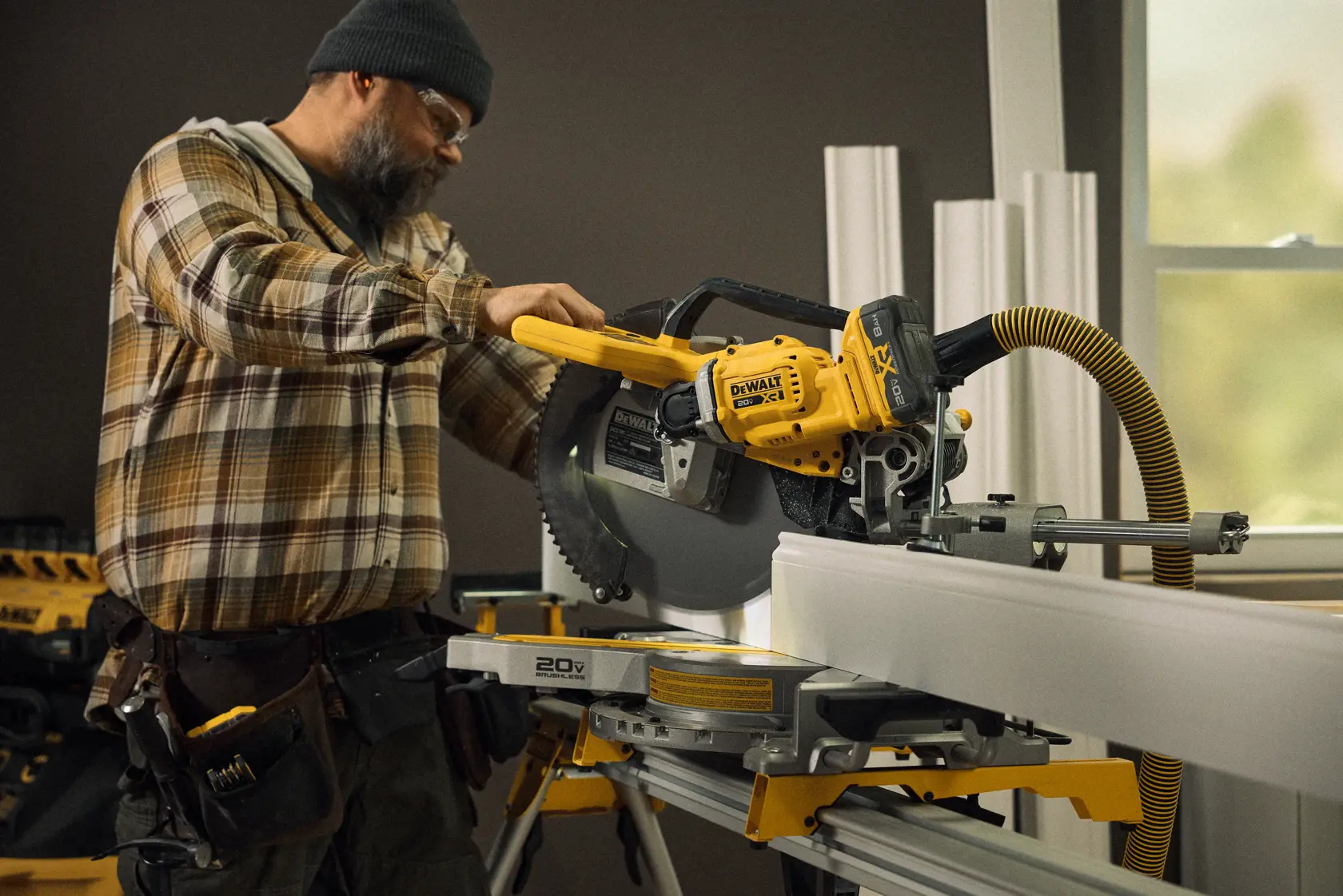 Talent cutting a piece of material with the 20V MAX* XR® 12in. Double Bevel Sliding Miter Saw Kit in a residential environment