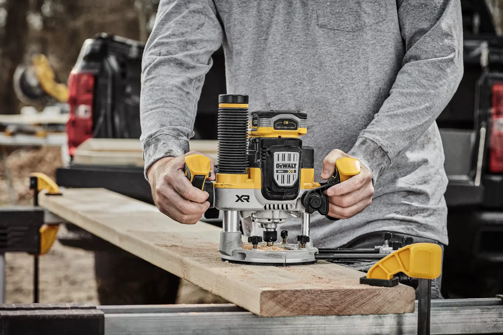 DEWALT XR 20V MAX* Plunge router with 20V MAX* XR 5 ah battery on wood surface in use