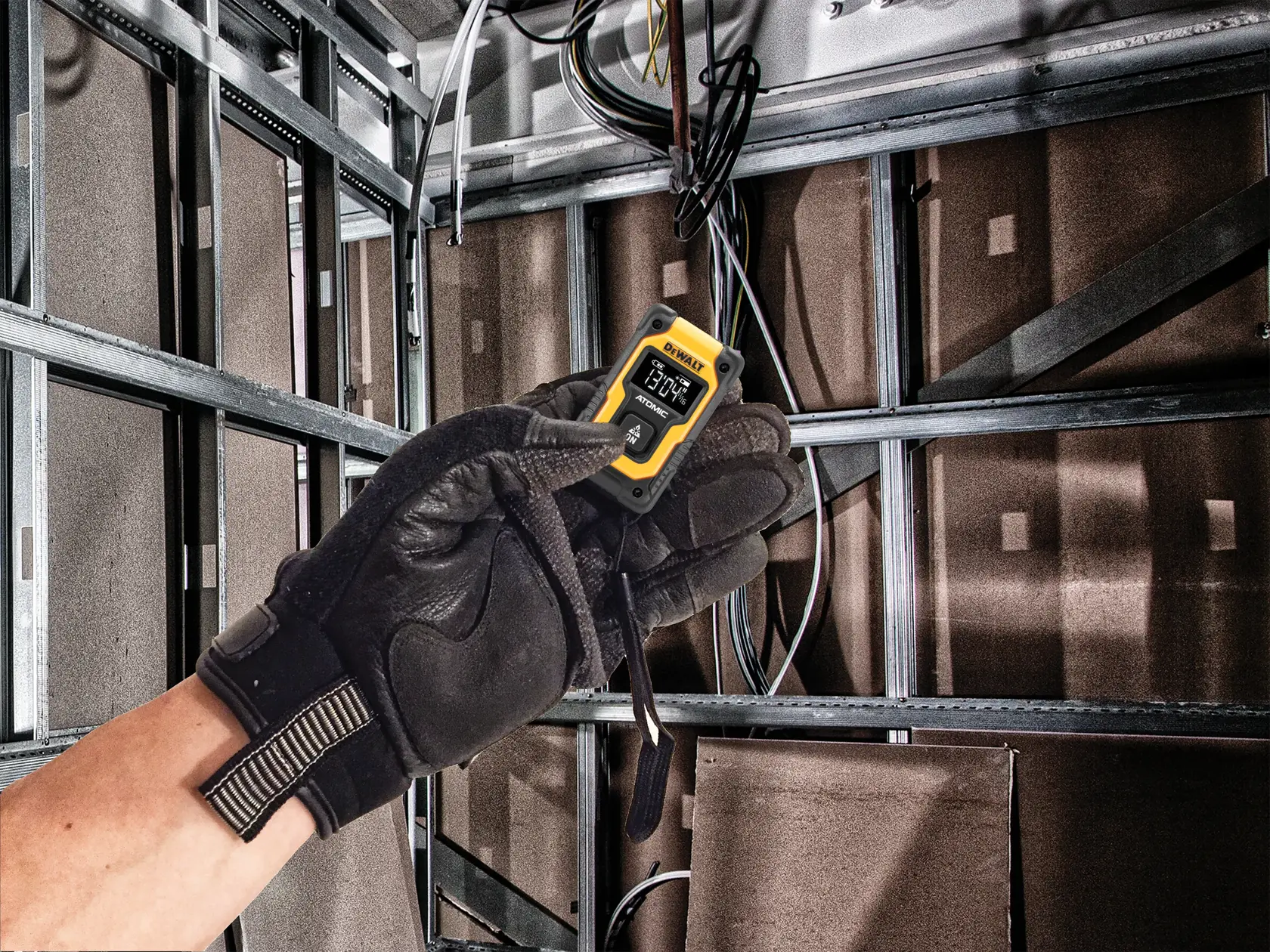 Atomic compact series pocket laser distance measurer being used to measure a distance.