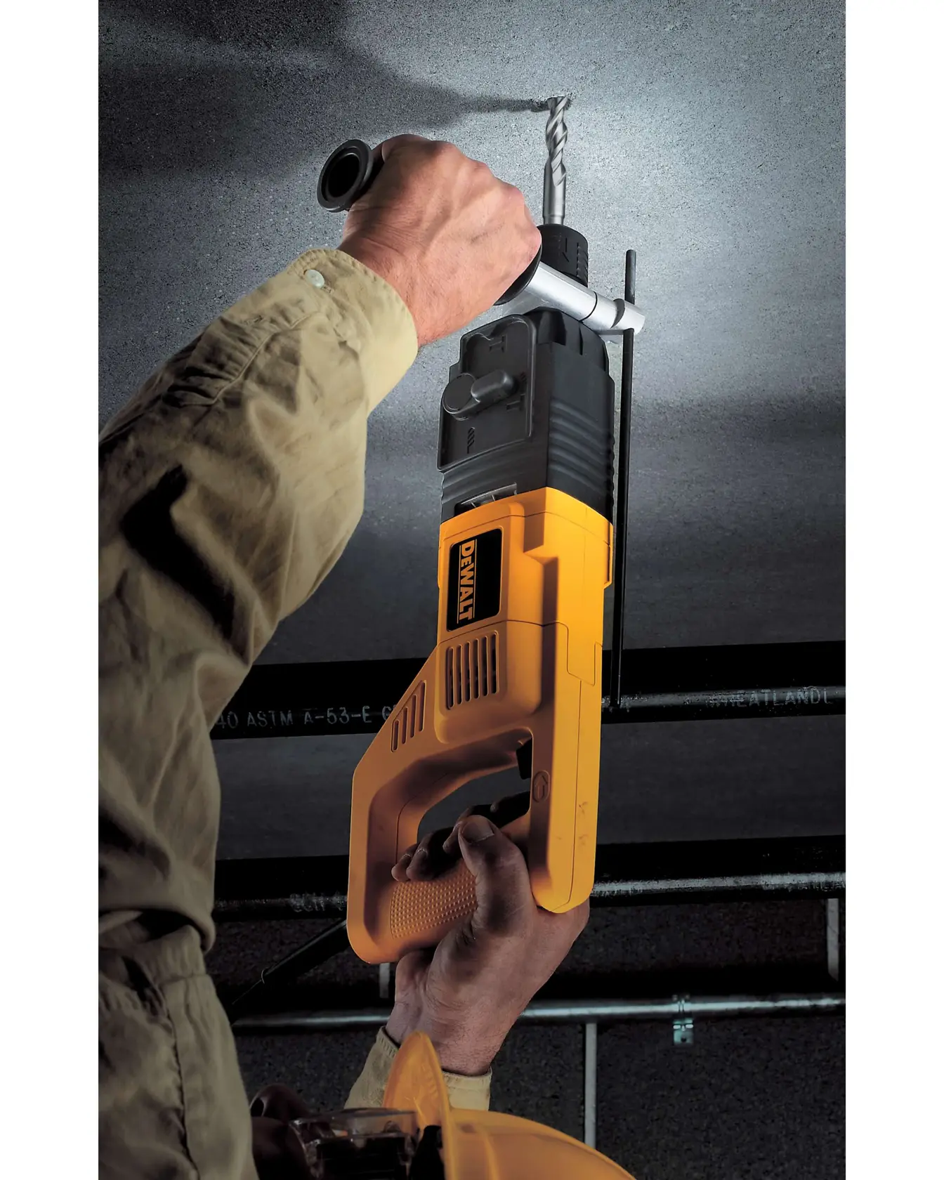 SDS Plus 2 Cutter Drill Bit being used by worker to drill hole through concrete ceiling.