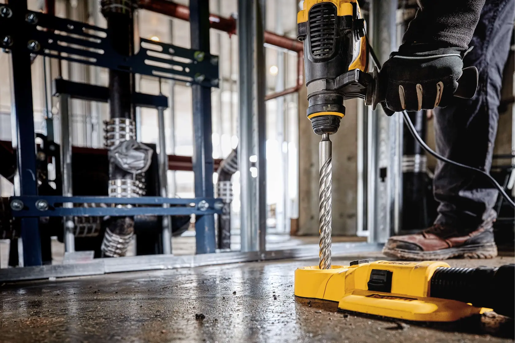 SDS Plus 2 Cutter Drill Bit being used to drill through floor at work site.