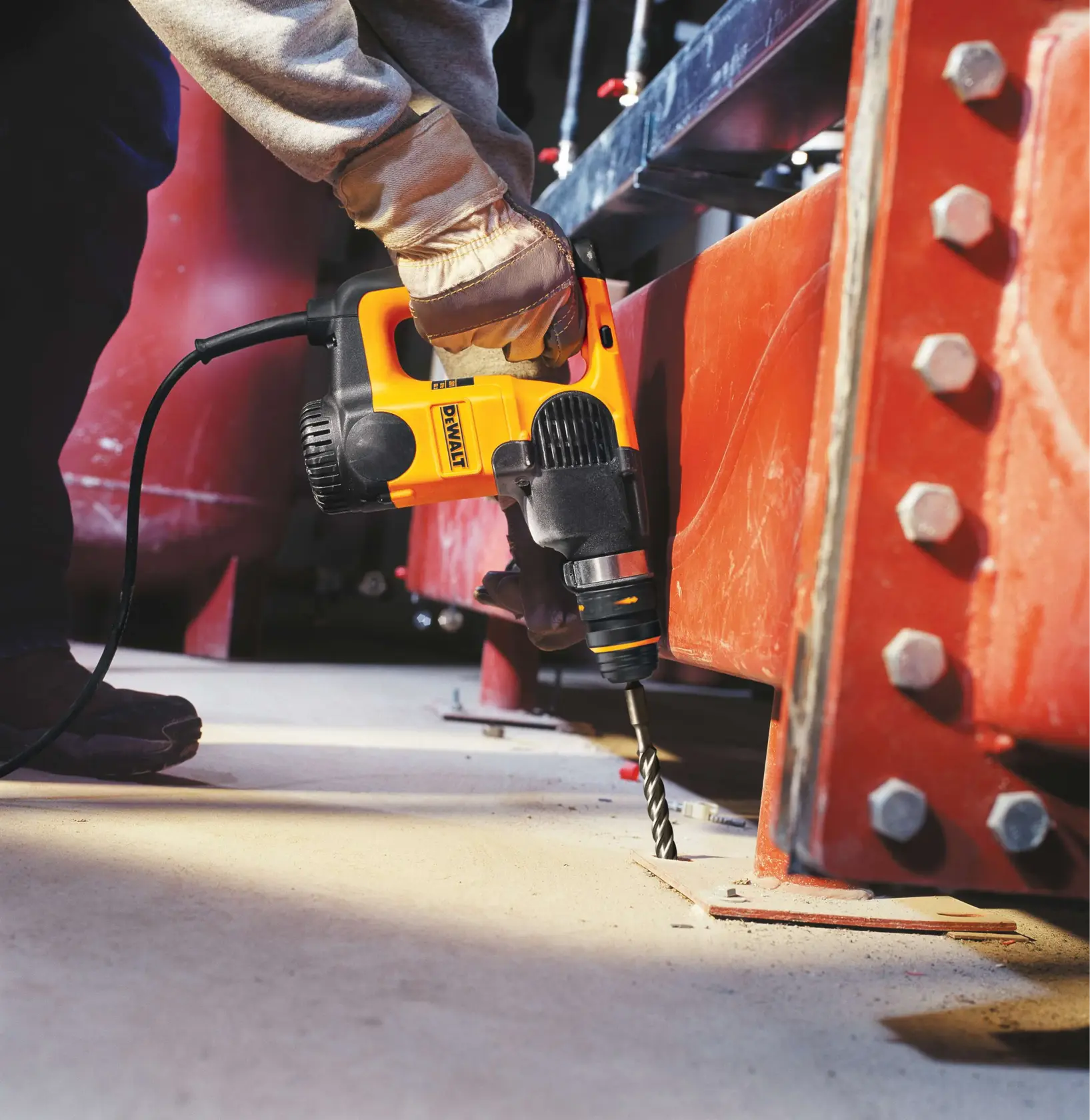 HIGH IMPACT CARBIDE SDS Plus Drill Bit being used to drill hole in ground at job site.