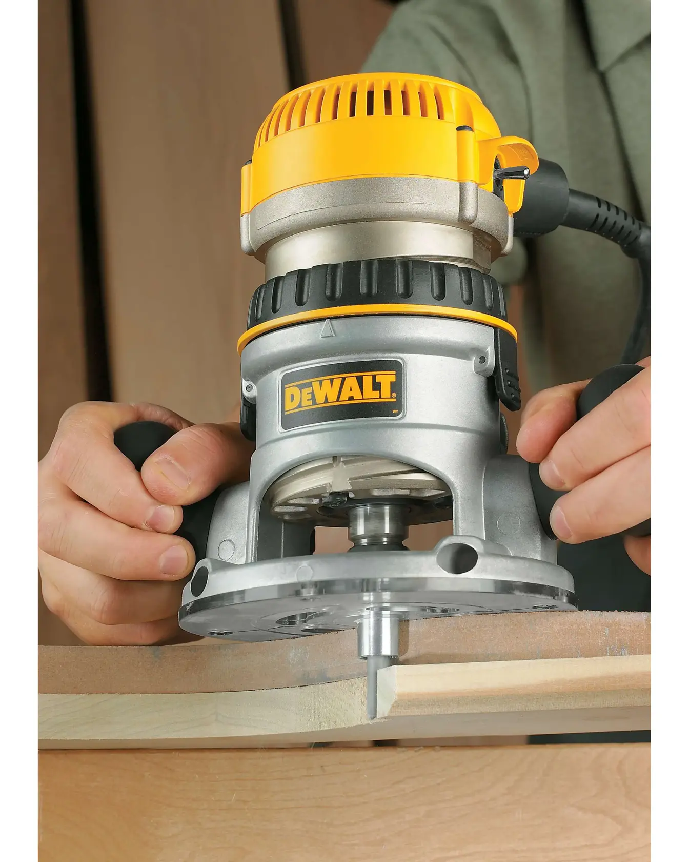 One and three quarters HP Fixed Base Router being used on edge of a wooden surface.