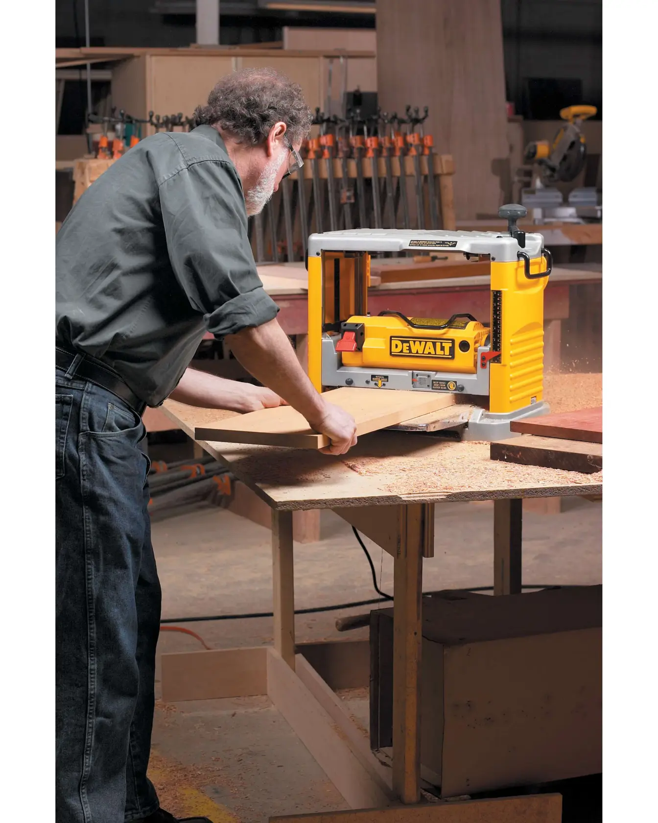12 and half inch Thickness Planer with Three Knife Cutter Head being used by a person on wooden board.