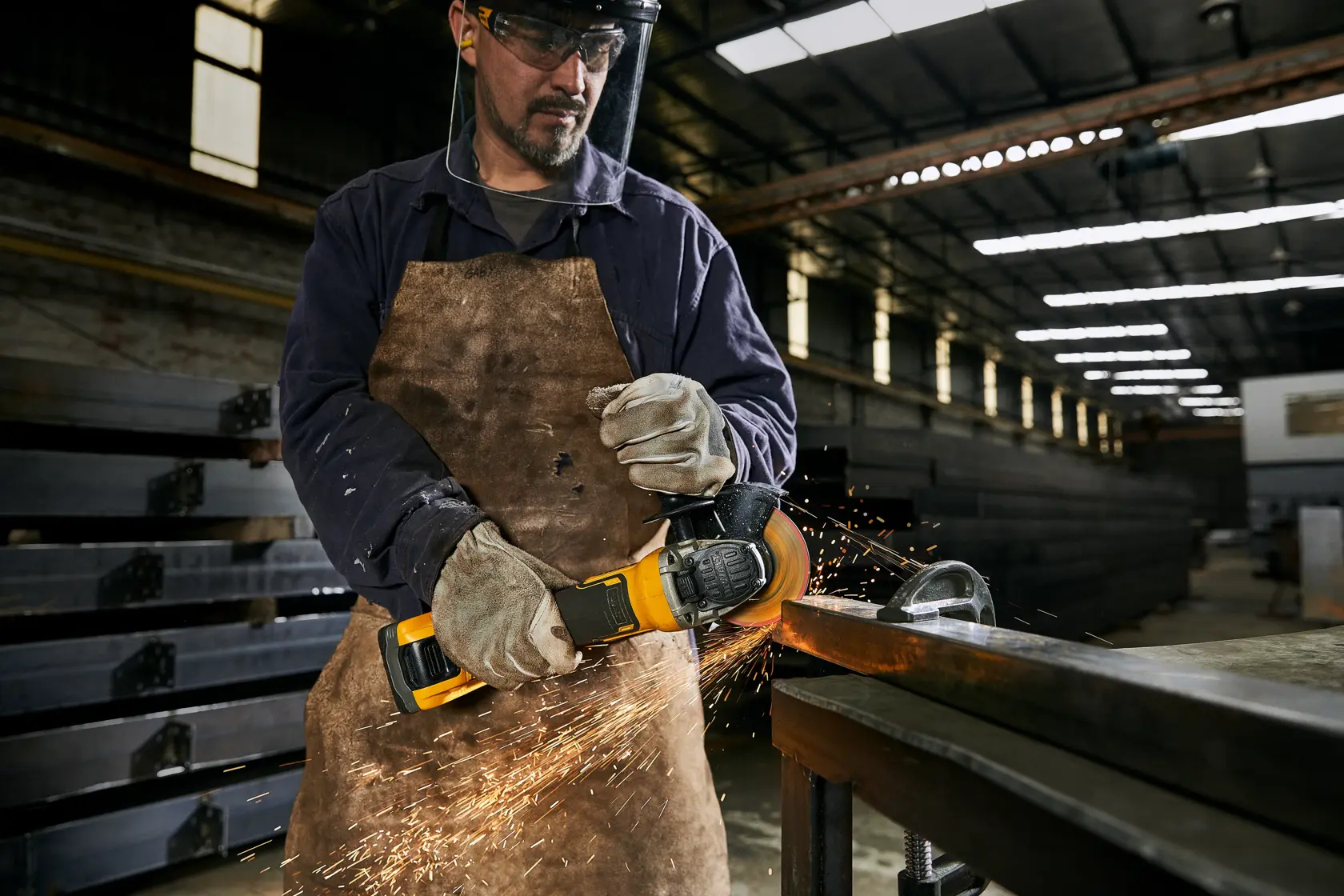 METAL FACTORY SIDE VIEW operator cutting steel profile in metallurgic plant