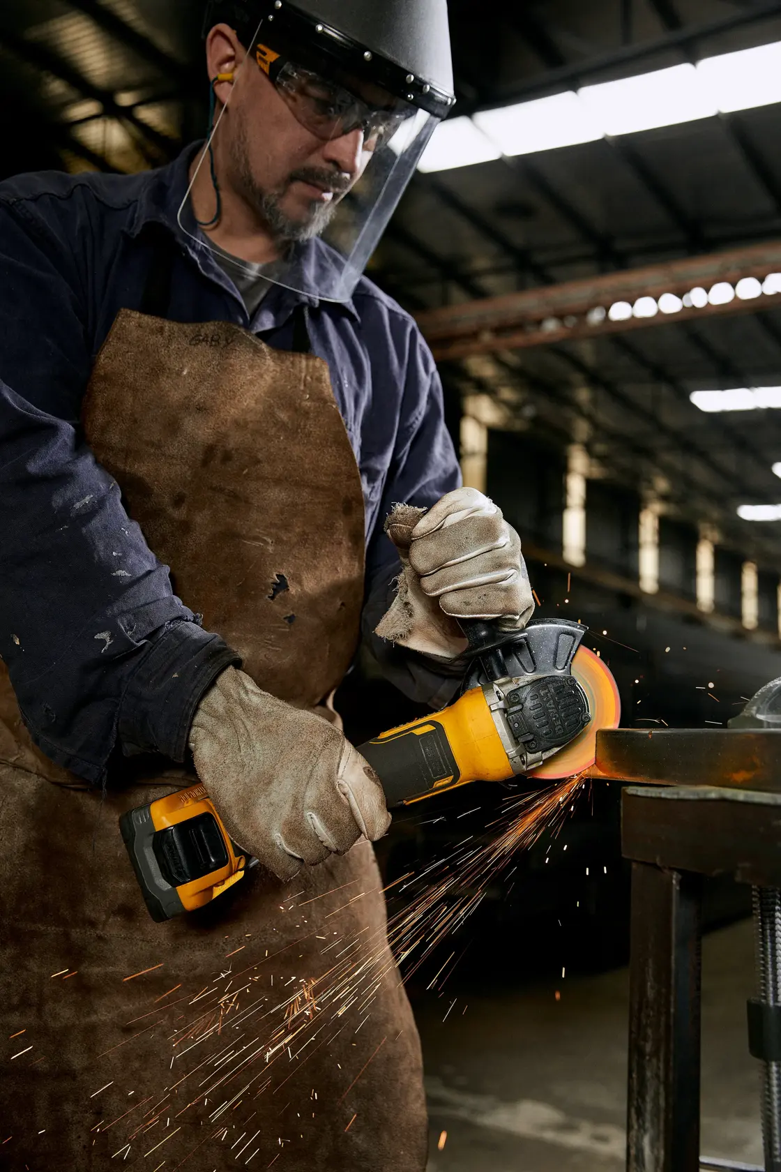 METAL FACTORY SIDE VIEW operator cutting steel profile in metallurgic plant