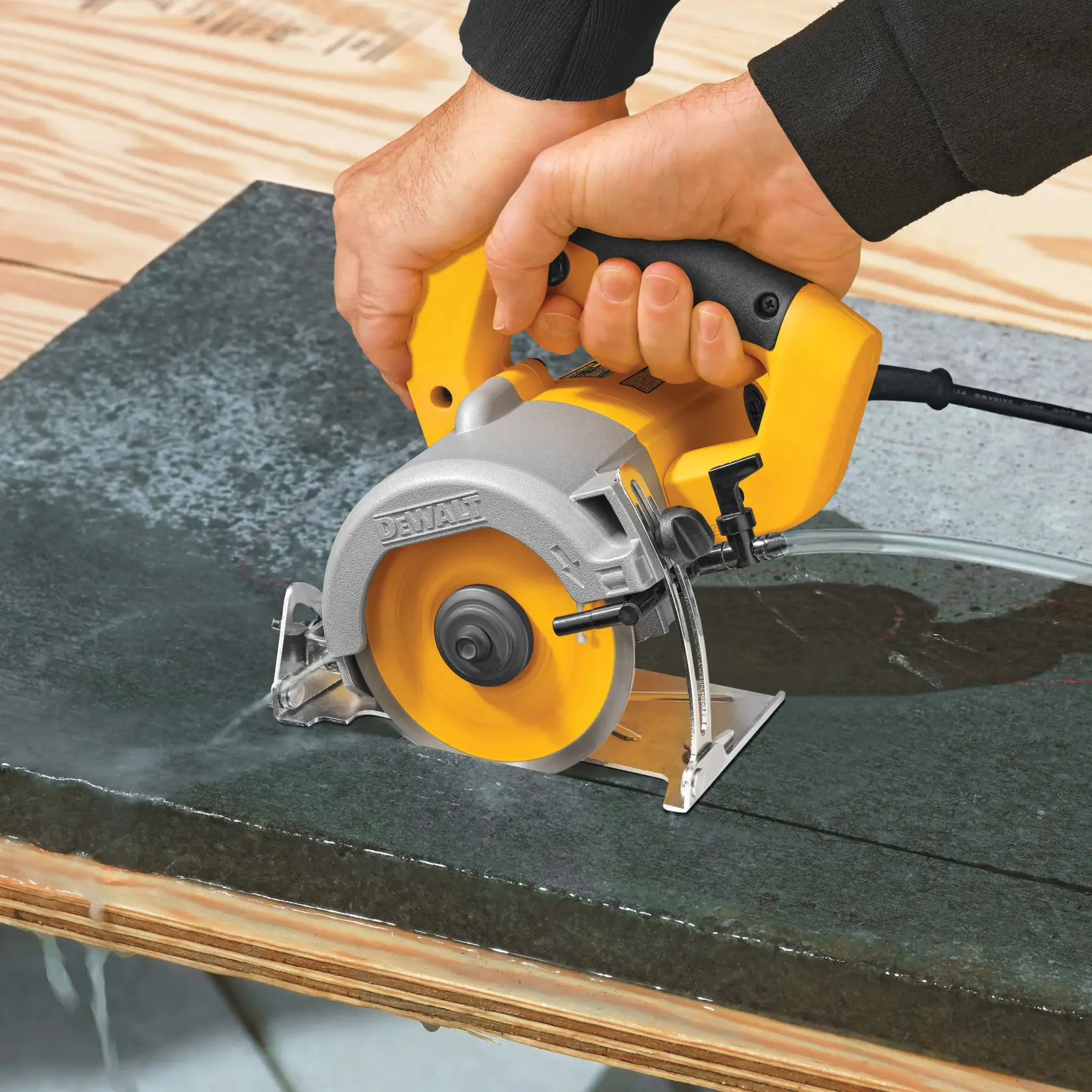Wet dry handheld tile cutter being used to cut tile.