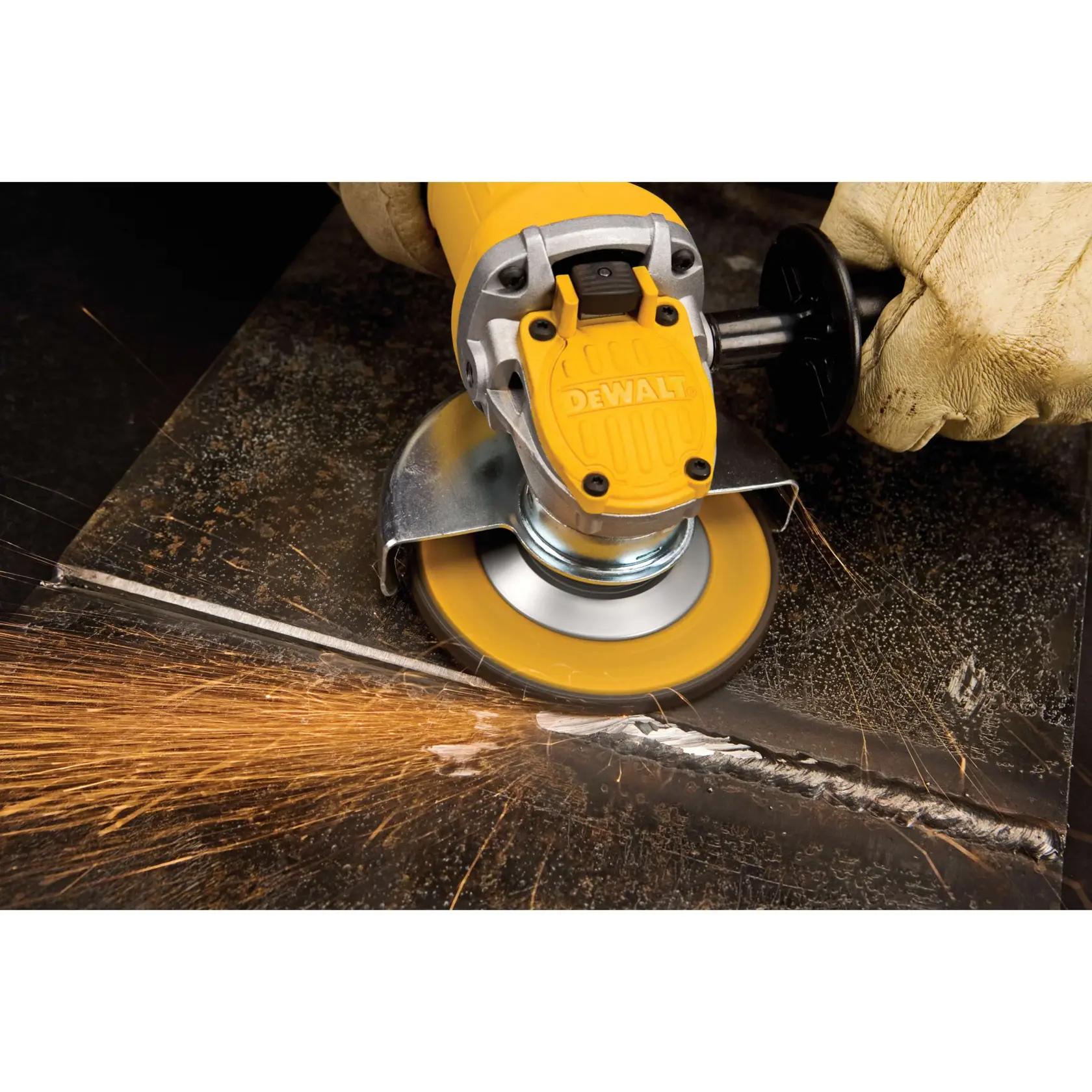Paddle switch small angle grinder being used to grind metal.