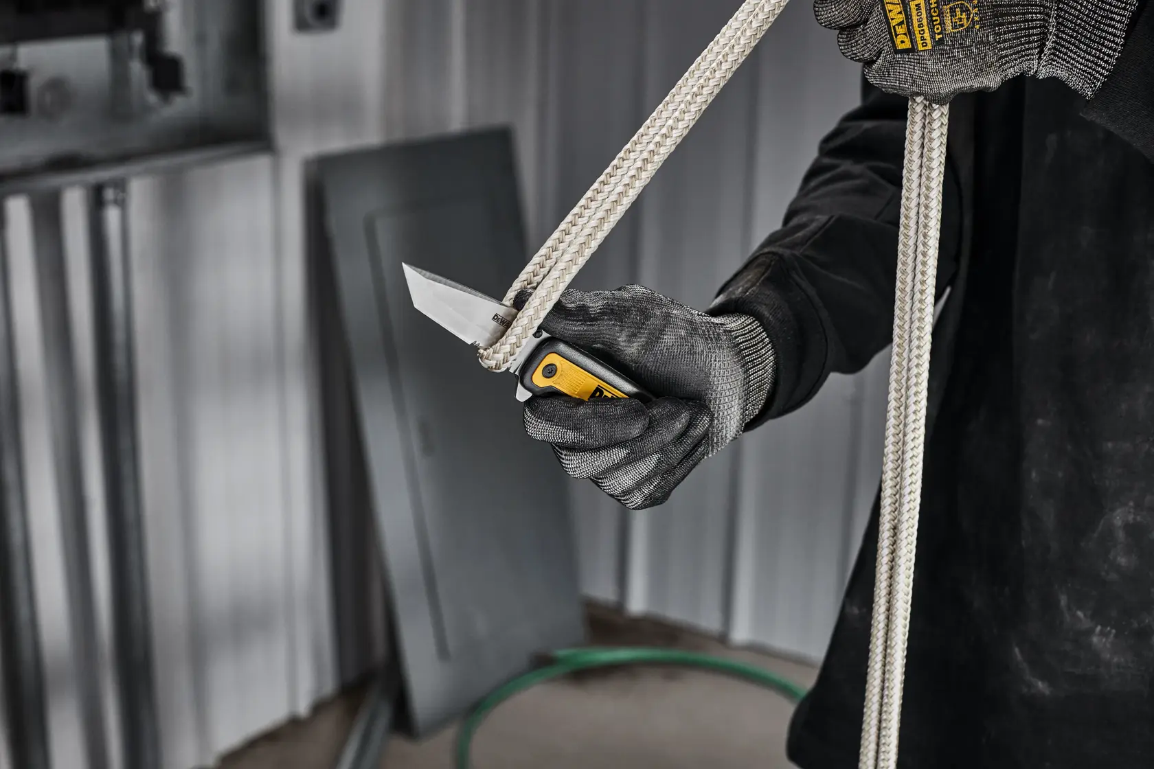 DEWALT pocket knife with serrated edge cutting rope