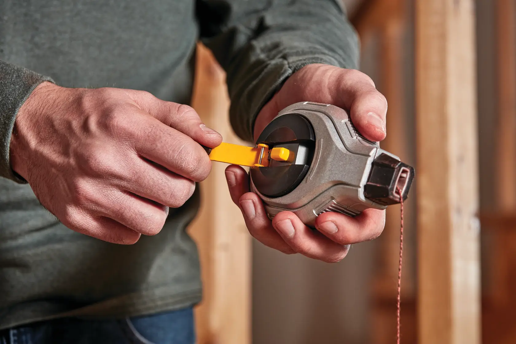 6 to 1 and ratio Chalk Reel Kit being retracted by person after use.