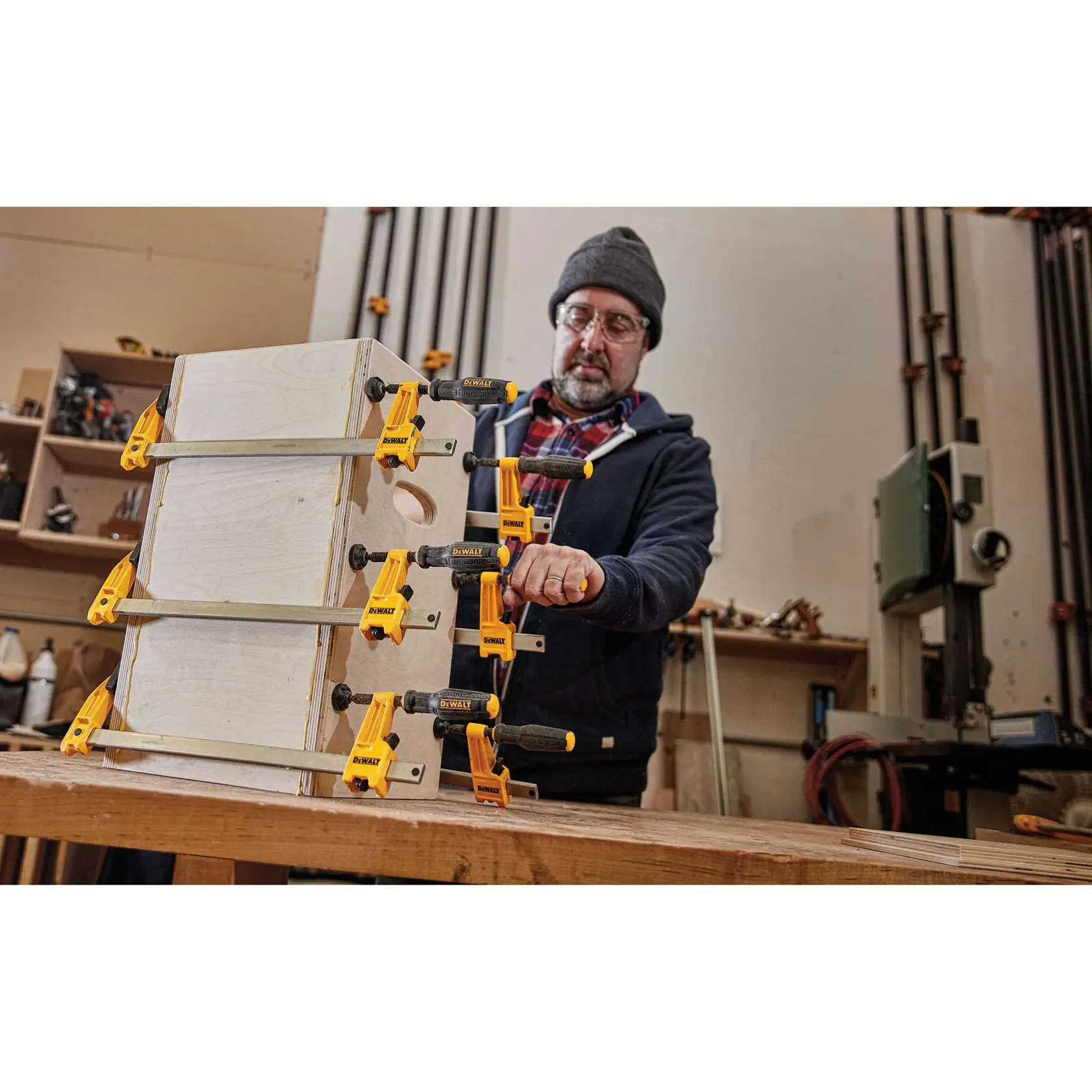 36 inch Bar Clamp being used on a wooden structure by a person.
