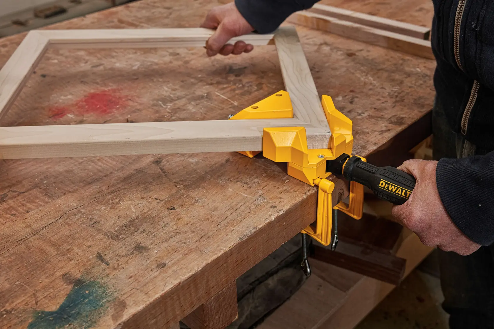 90 Degree Angle Clamp being used by a person on a wooden frame.