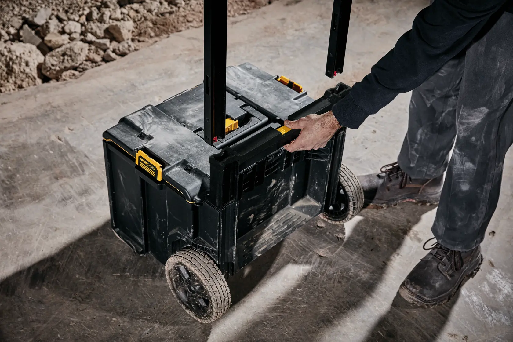 Handle of tough system 2.0 rolling toolbox being removed at a worksite.