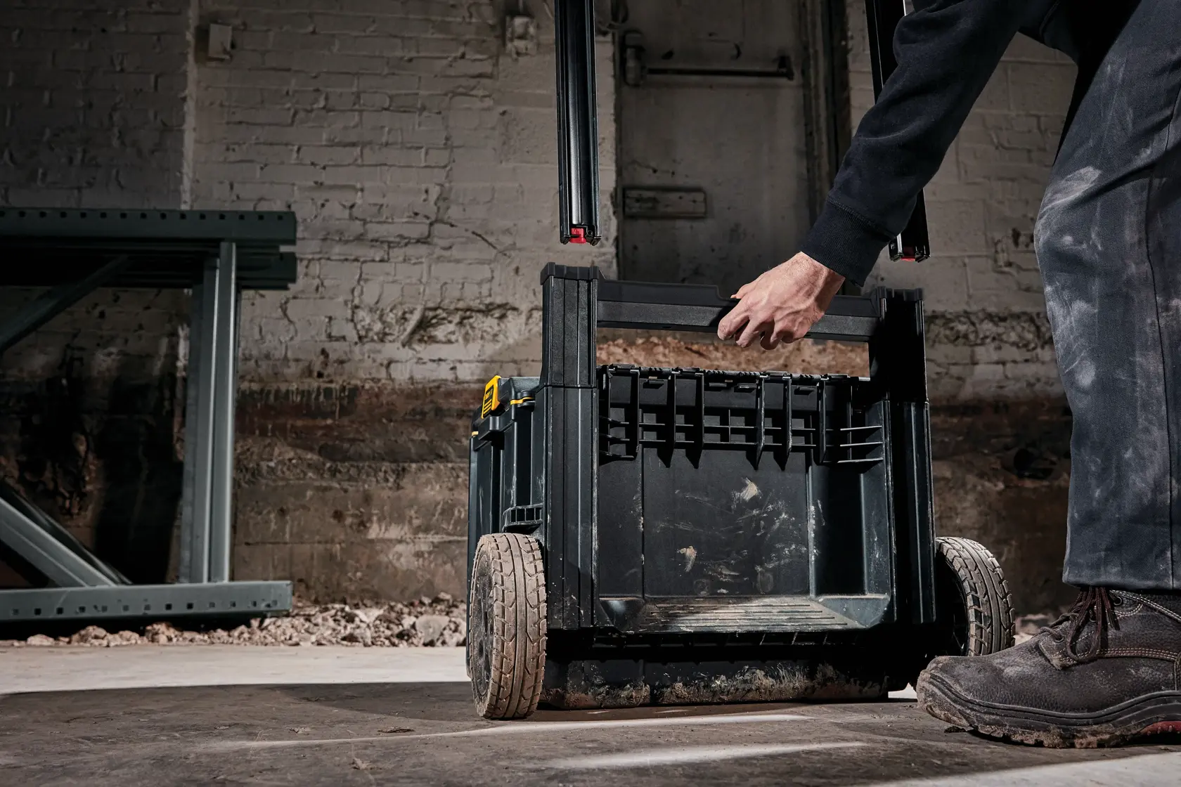 Handle of tough system 2.0 rolling toolbox being adjusted at a worksite.