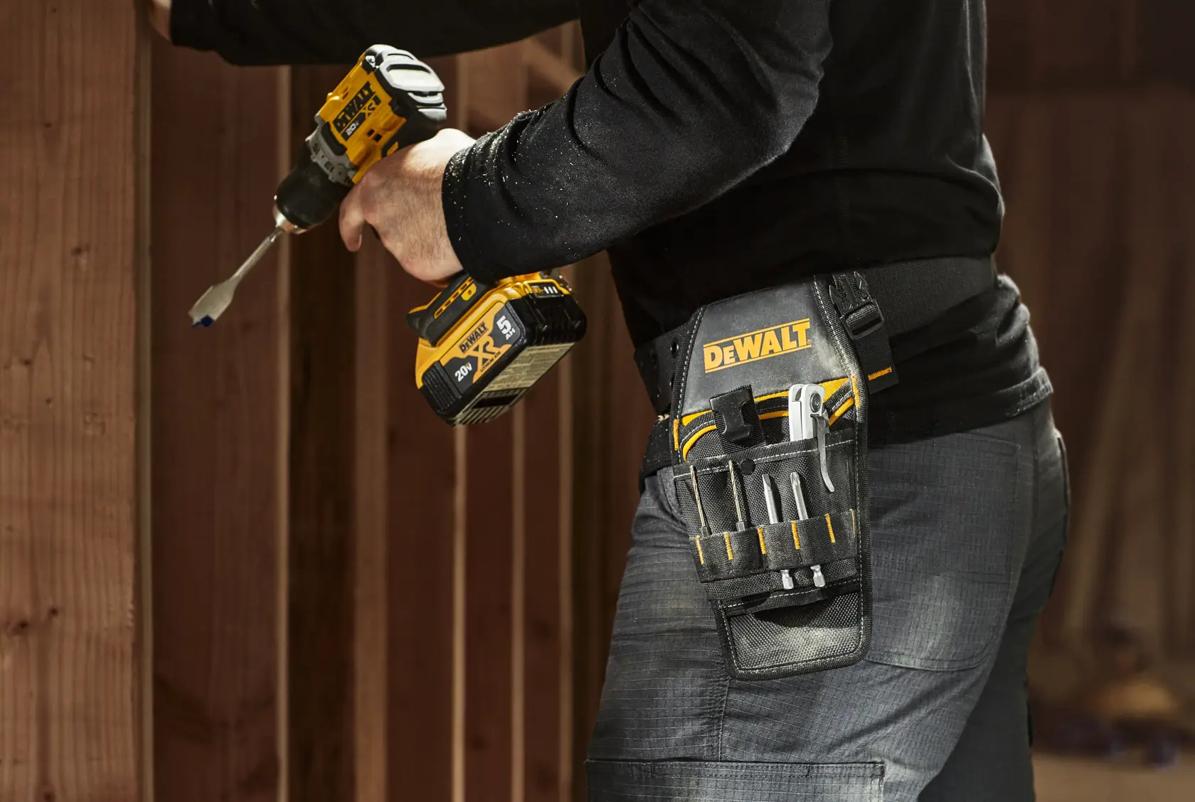 CONSTRUCTION WORKER WEARING DEWALT PROFESSIONAL DRILL HOLSTER